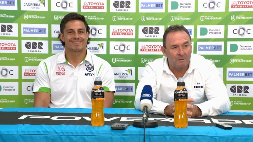 Joe Tapine smiles as Ricky Stuart talks in a post-match press conference.