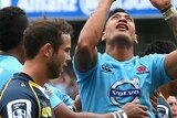 On top ... Israel Folau celebrates scoring a try for the Waratahs