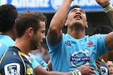 On top ... Israel Folau celebrates scoring a try for the Waratahs