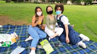 Photo of three women enjoying a picnic in Melbourne in December 2020.