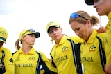 Australian players in a huddle look worried.