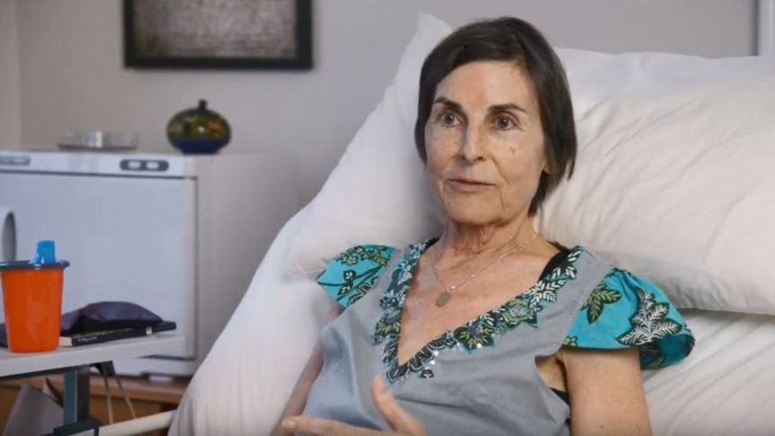 Judith McIntyre in 2014, sitting in a hospital bed.