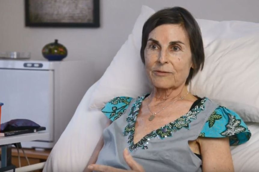 Judith McIntyre in 2014, sitting in a hospital bed.