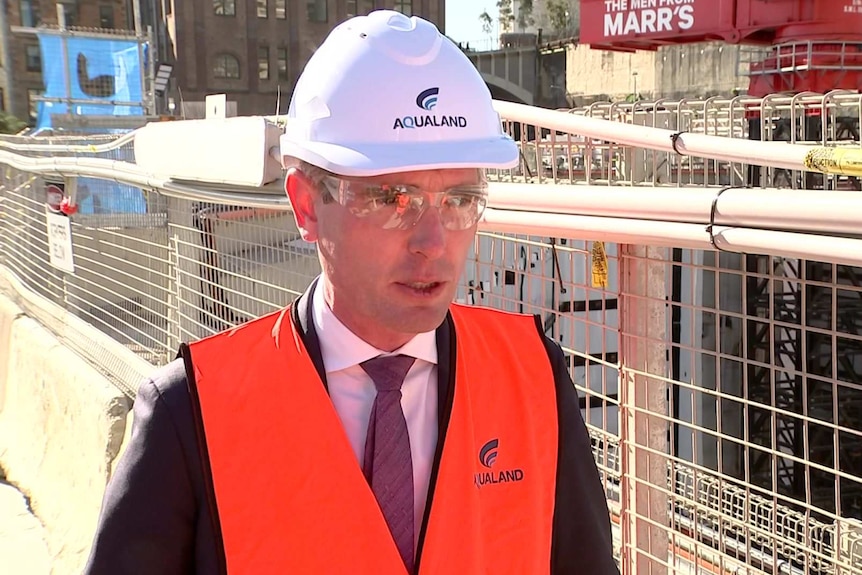 A man in a hard hat talking.