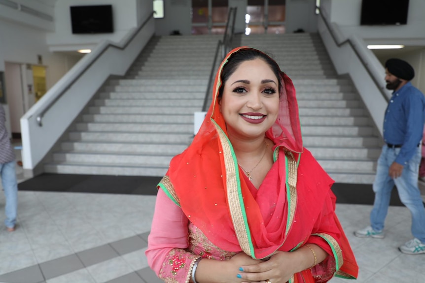 A woman wearing a red sari