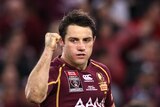Man of the moment ... Cooper Cronk celebrates after kicking the winning field goal