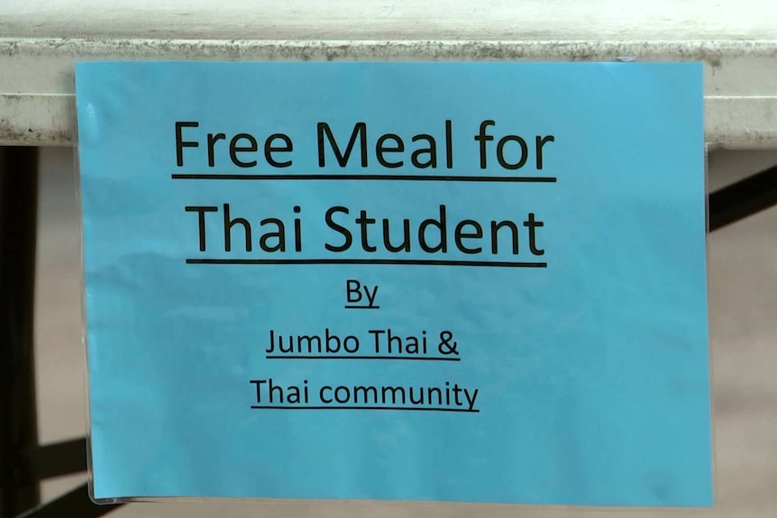 a sign that reads free meal for thai student