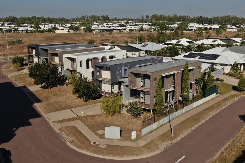 Six modular, modern looking townhouses seen from a high angle.