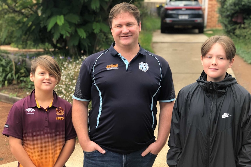 Riley, Dan and Lachlan pose on the street.