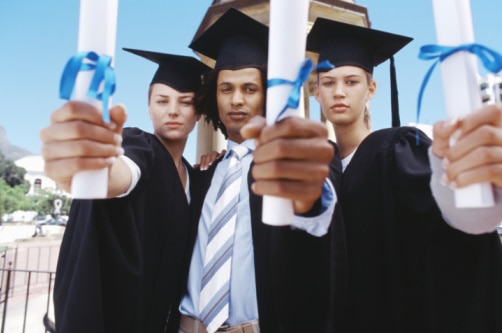 Creative: Three graduate students holding diplomas, outdoors (Stockbyte: Thinkstock)