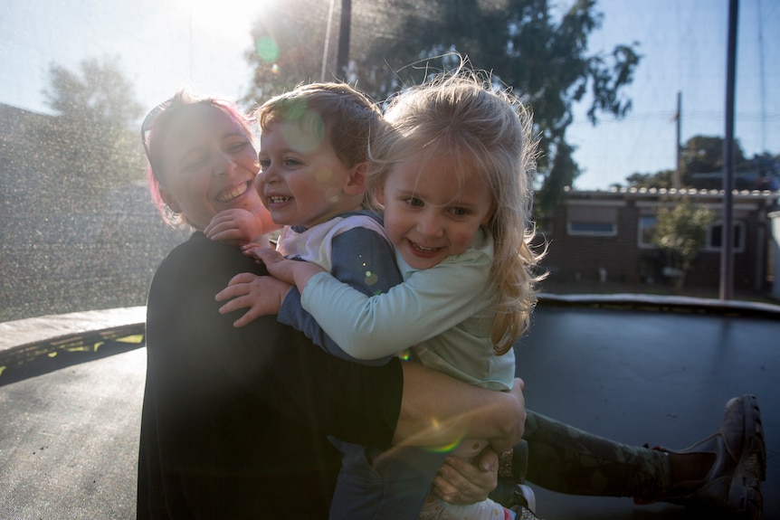 Amber Roman and Nara hug each other on the trampoline.