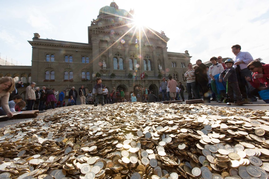 Universal basic income activists dump coins in a public square in the Swiss city of Bern.