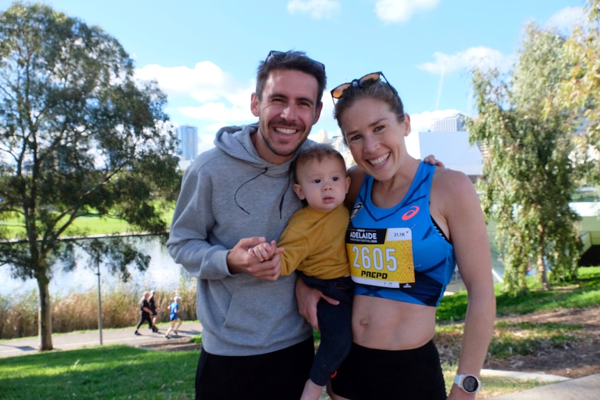 Dylan and Jessica Stenson carrying their son