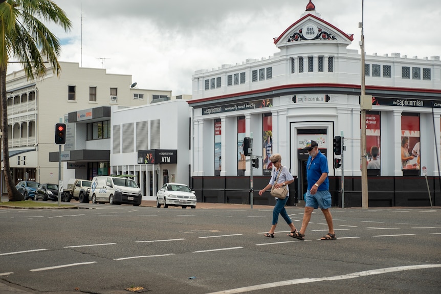 People walk across the road at an intersection in Rockhampton CBD, November 2021.