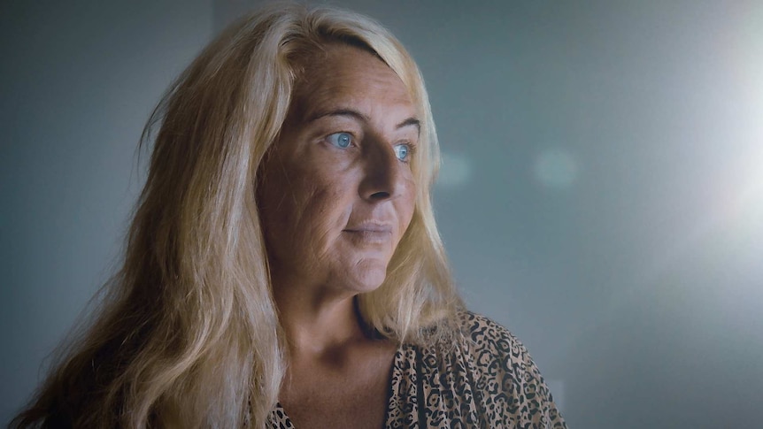 Nicola Gobbo, known as Lawyer X, wearing a leopard print top stares out a window
