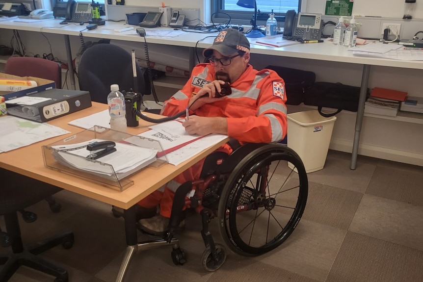 man sitting in an emergency service style room with radio equipment around him