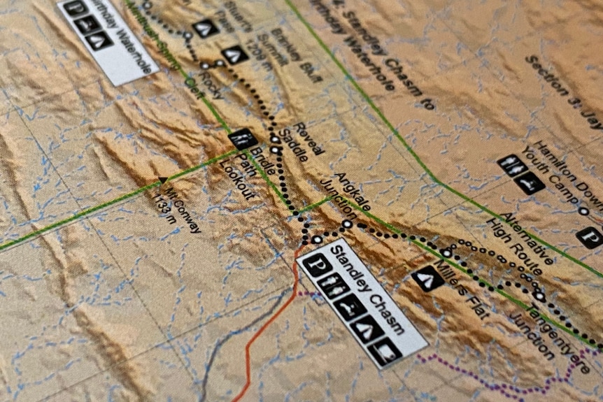 map contours on map with black images denoting parking, camping, coffee.