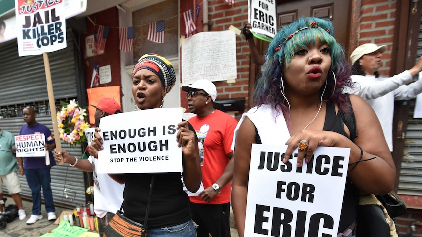 Protesters gather at the spot where Eric Garner died