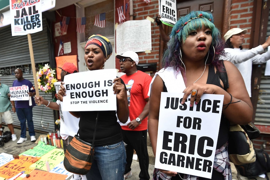 Protesters gather at the spot where Eric Garner died