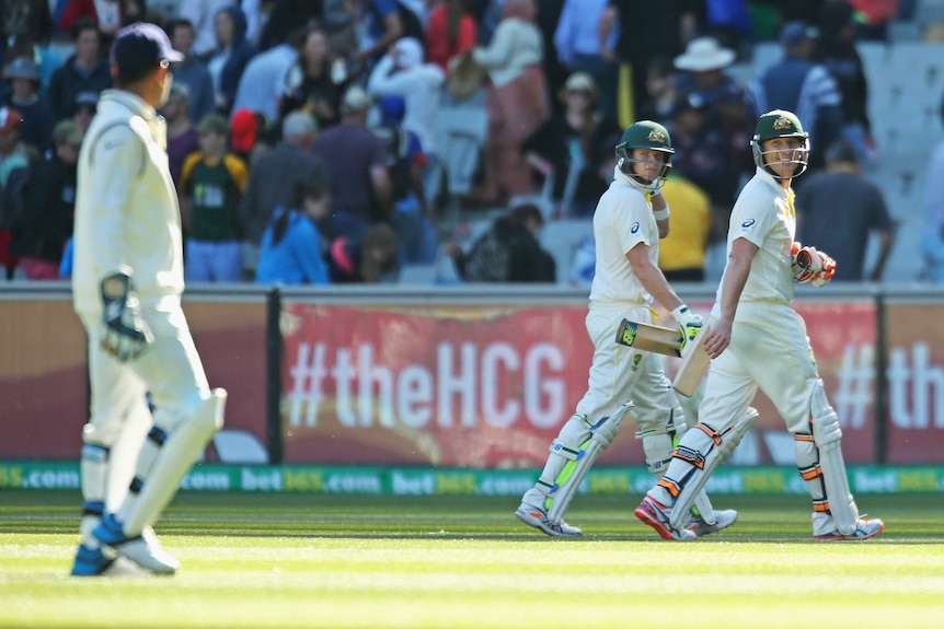 Steve Smith and Brad Haddin exchange words with MS Dhoni after day one of the third Test at the MCG