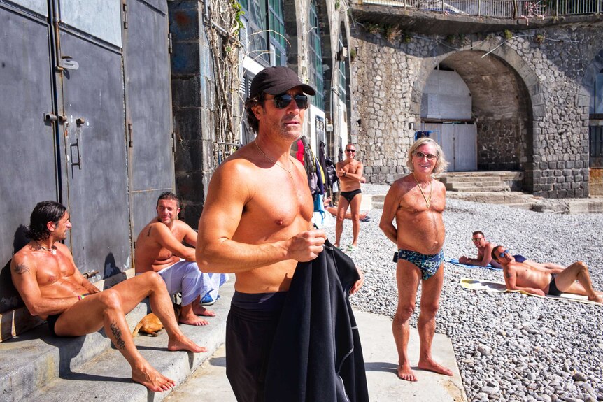 Italian men shirtless on a beach