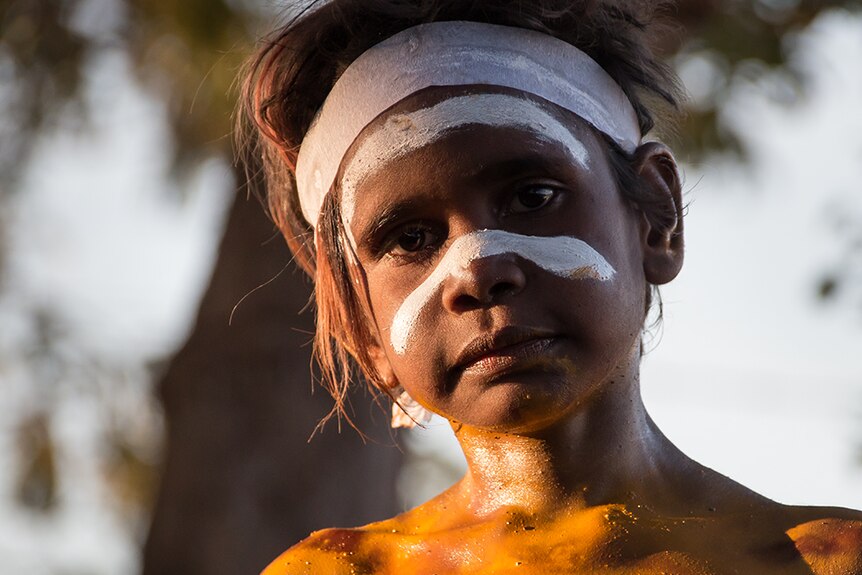 An Aboriginal boy in traditional facepaint at the 50th anniversary of the Wave Hill walk-off.