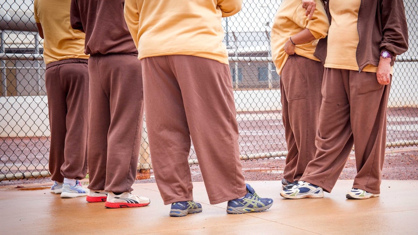 Five women standing together inside a prison in Kalgoorlie-Boulder