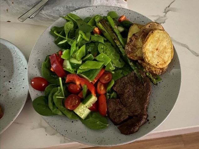 A delicious-looking plate of veggies and lean steak for dinner.