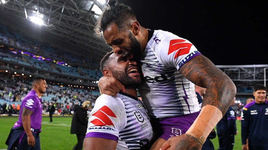 Melbourne Storm players Justin Olam and Josh Addo-Carr hug after the 2020 NRL grand final.