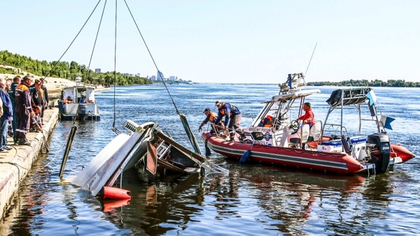 Emergency services attend to overturned boat in Russia