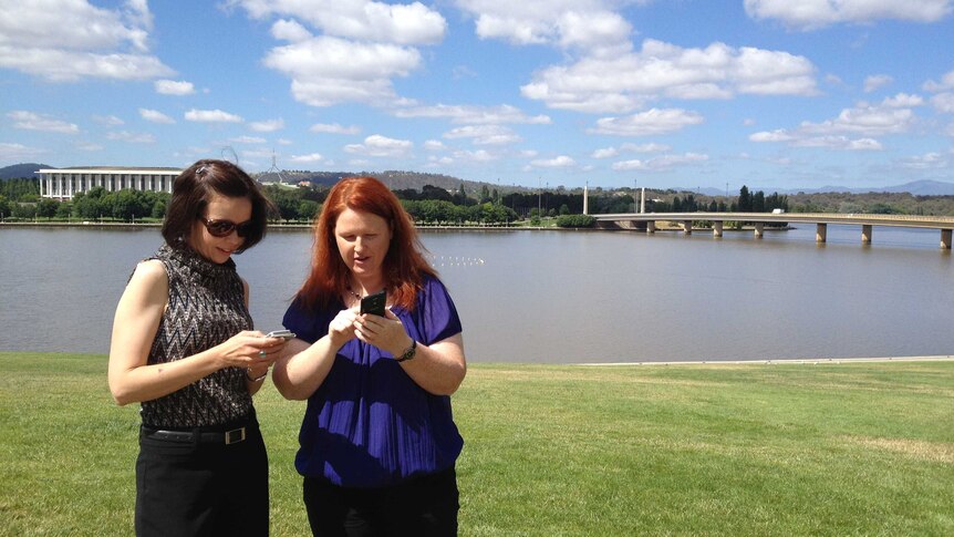 Nicole Hoffman and Heather Millard from the National Capital Attractions Association check out the new app.