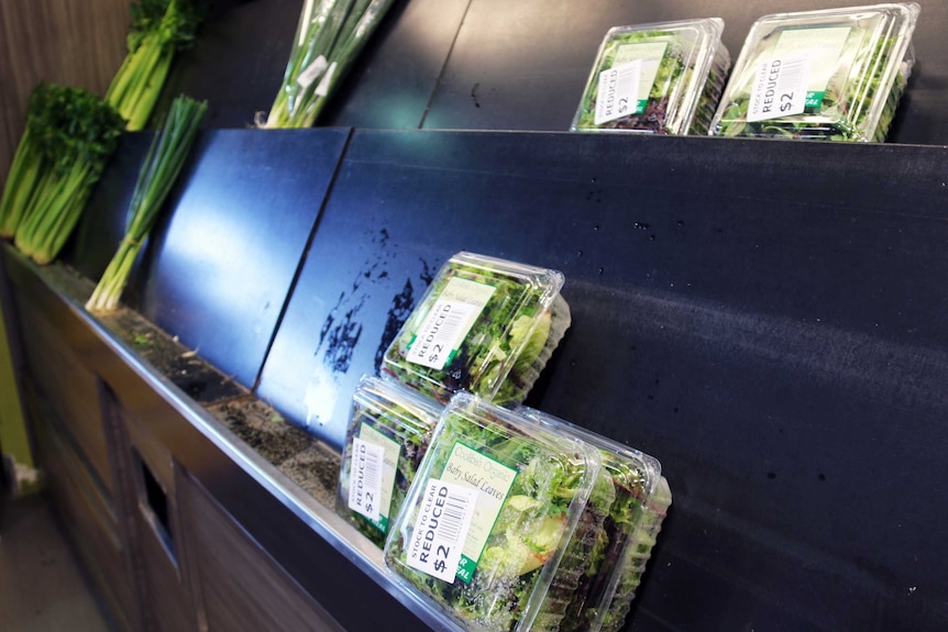 Empty shelves at Fyshwick Markets with discounted lettuce