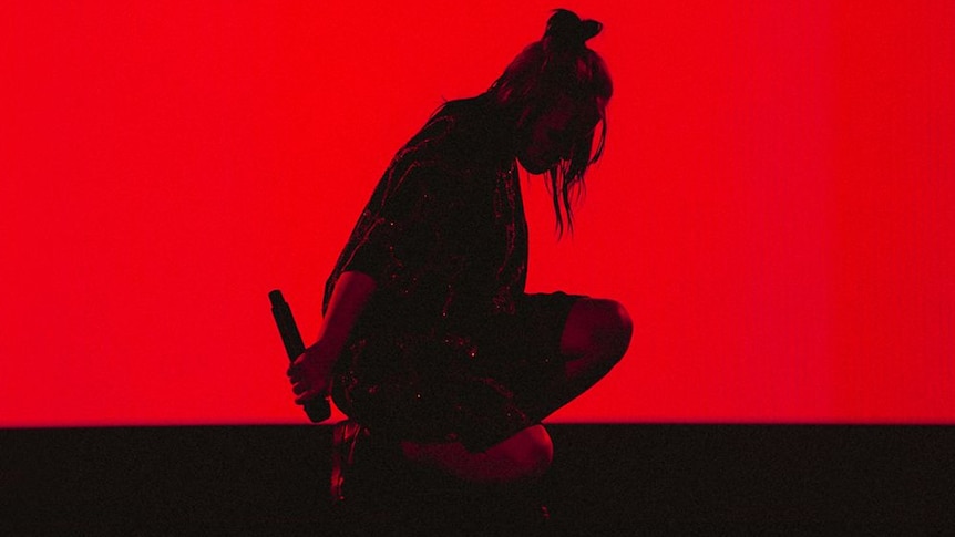 Red and black silhouette image of Billie Eilish