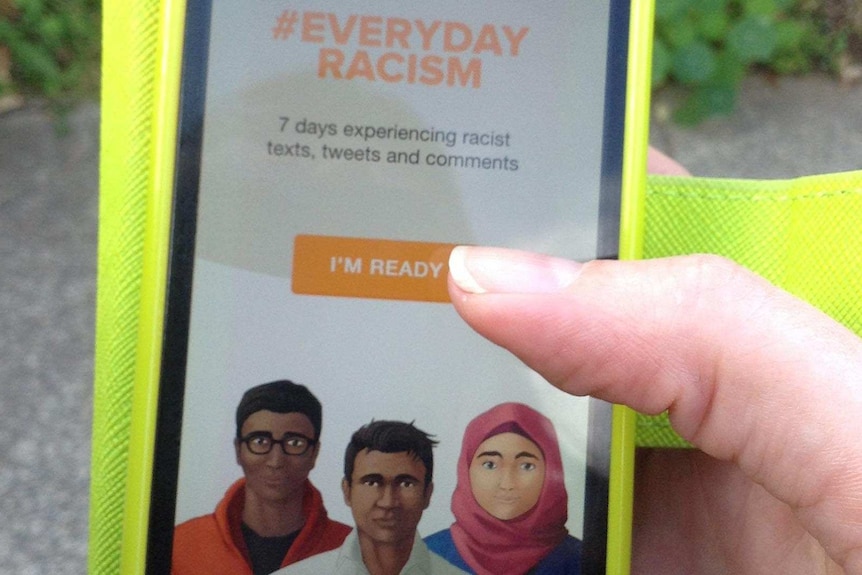 Hand holding mobile phone with the text "#Everyday Racism"