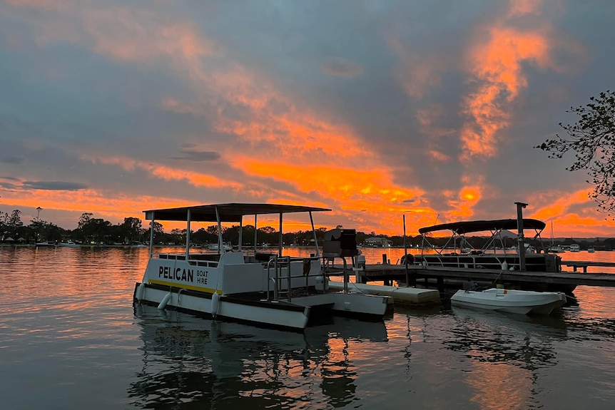 A sunset shot of boats on the noosa river