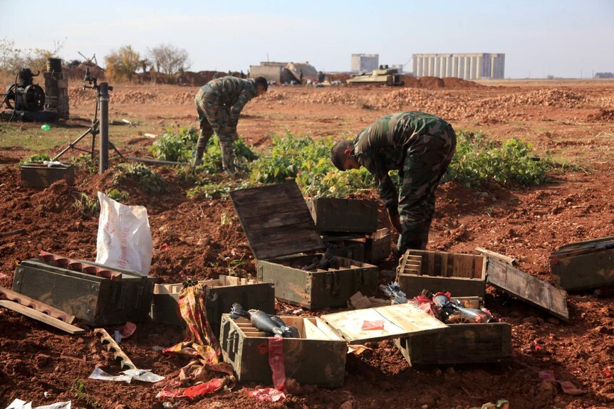 Syrian forces check through boxes of artillery left by Islamic State.