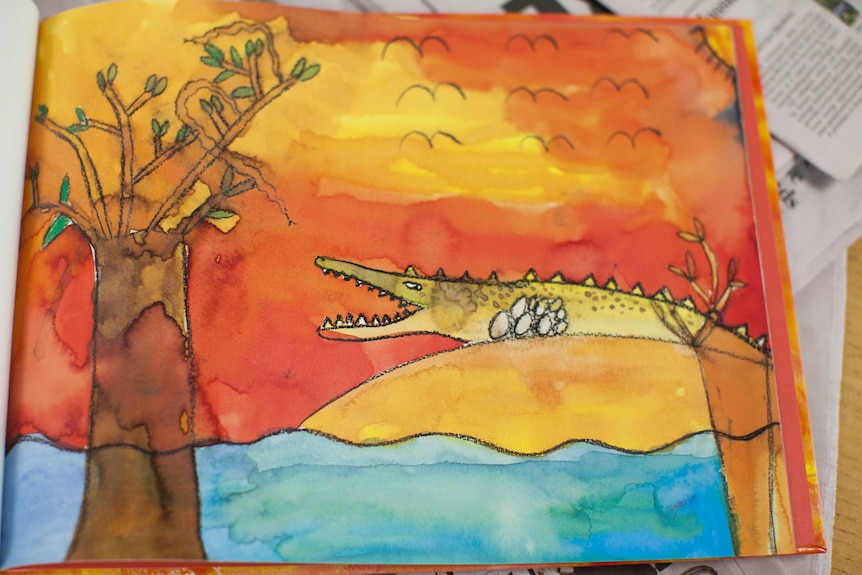 A watercolour drawing of a crocodile beside a tree