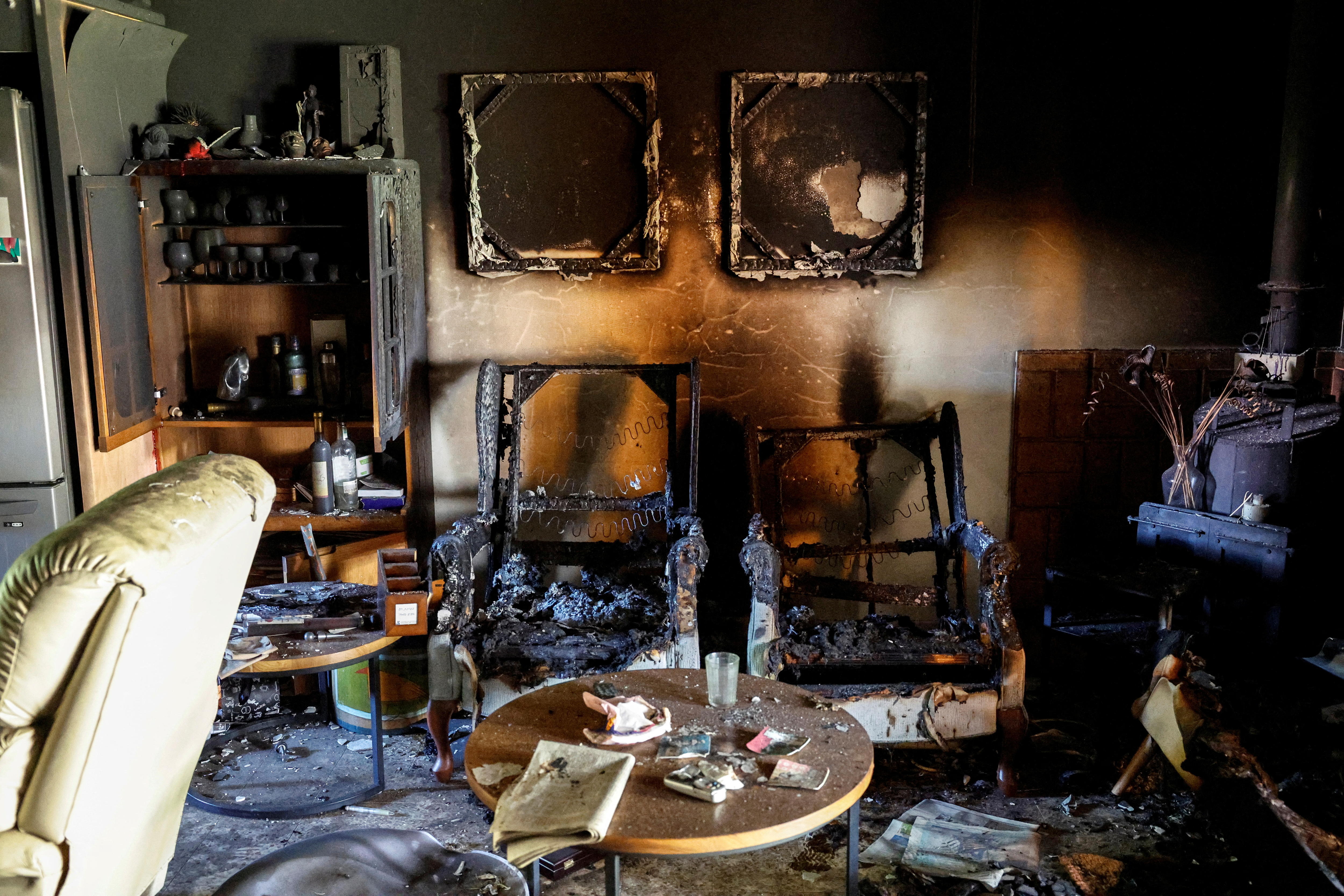 The charred remains of chairs, paintings and other furniture inside a destroyed family home in Kibbutz Nir Oz.