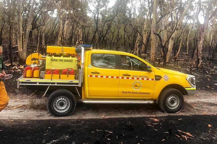 Rural Fire Service vehicle parked on a burnt-out sand track from a bushfire on Fraser Island off south-east Queensland.