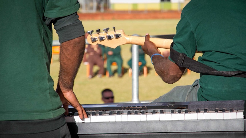 A guitarist and keyboard player perform at the battle of the bands.