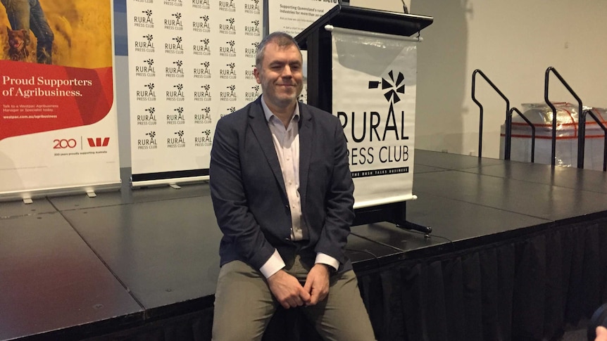 A red meat senior executive sits in front of Rural Press Club stage, where he's given a keynote address to industry