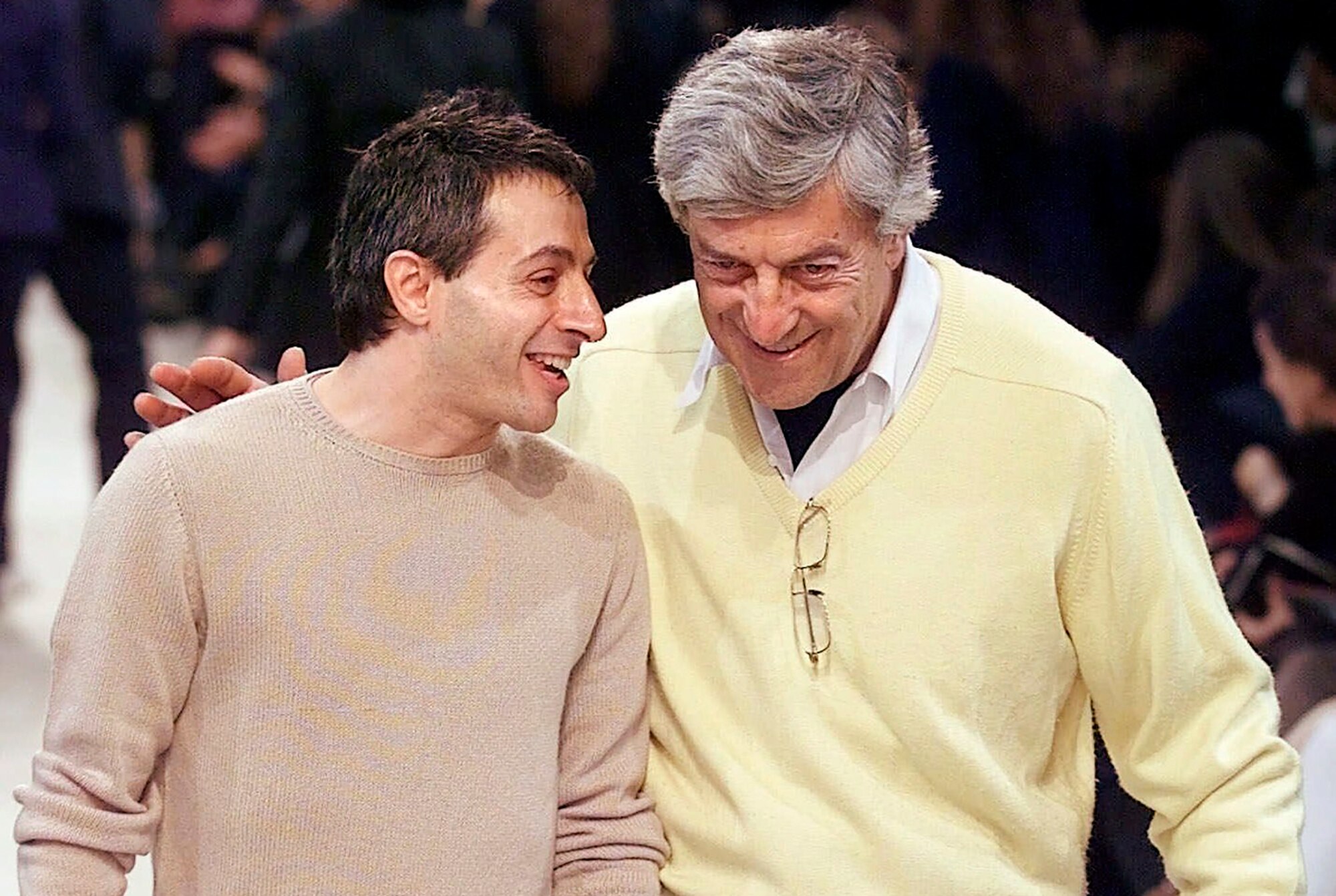 two men on a fashion runway laughing