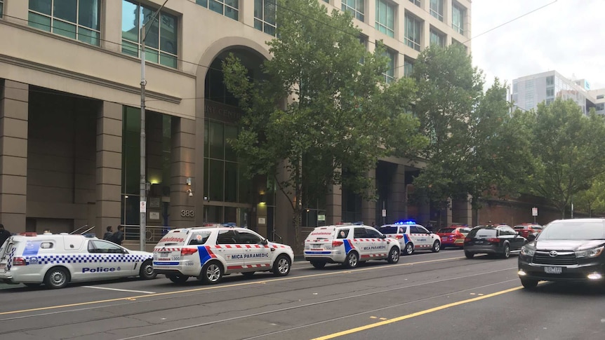 Paramedics on La Trobe Street after a female AFP officer sustained a gunshot wound.