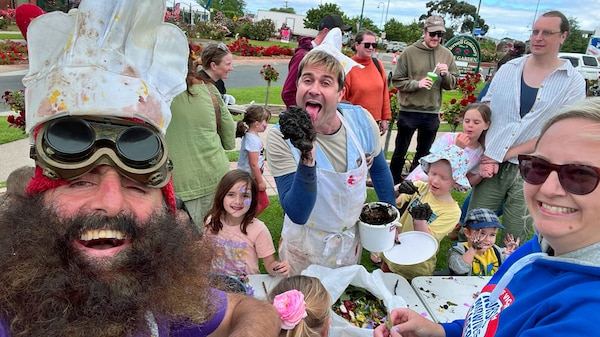 Costa the Garden Gnome and Scrapboy outside making mudpies with a group of children.