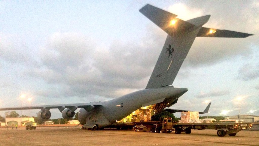 A C-17 aircraft is loaded with goods