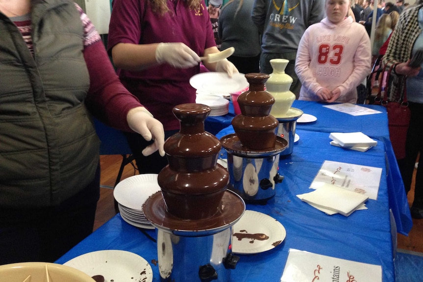 Chocolate fountains on table.