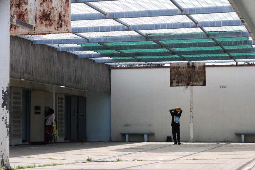 A basketball court inside a prison block.