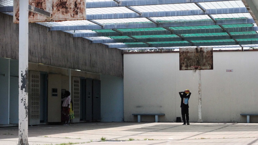 A basketball court inside a prison block.