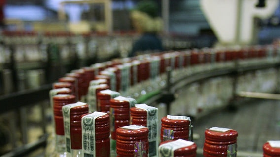 Bottles of vodka move along a conveyor belt