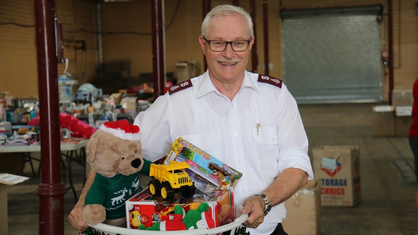 Salvation Army's Major Neil Dickson holding a basket of toys